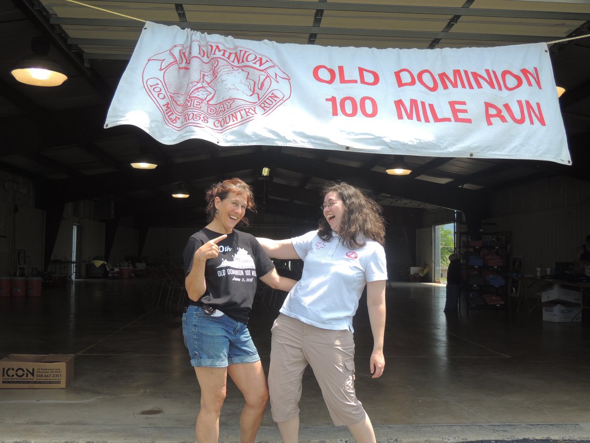 Nurse Kelly and Dr. Kim stand under the classic Old Dominion banner at the fairgrounds